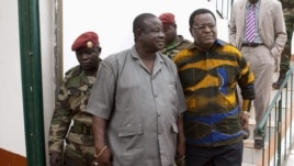 Guinea-Bissau's army chief of staff Antonio Indjai (C) and head of the national electoral commission Desejado Lima da Costa (R) arrive at a news conference at military headquarters in the capital Bissau, March 19, 2012.