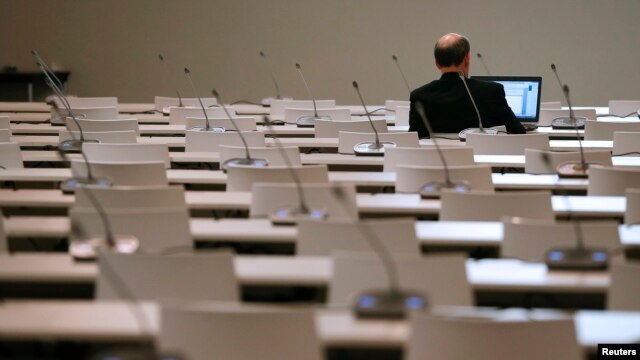 A participant works in a meeting room during the World Climate Change Conference 2015 (COP21) at Le Bourget, near Paris, France, Dec. 11, 2015.