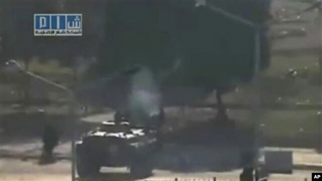 This image, posted on the Internet by Shaam News Network, shows what they purport to be a military tank on the streets of the city of Hama, Syria, on the 'third day of Ramadan,' Wednesday August 3, 2011