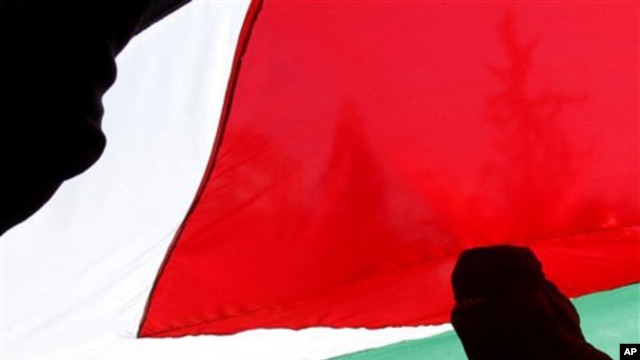 Palestinian women mark the International Women's Day and call for national reconciliation between the rival Palestinian leading factions Hamas in Gaza and Fatah in the West Bank, as they participate in a rally in Gaza city, March 8, 2011
