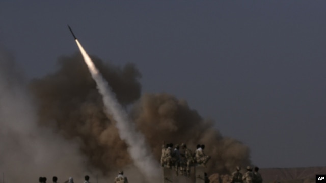 Members of Iran's revolutionary guard launch a surface to surface missile during exercises near the city of Qom in June, 2011 (file photo).