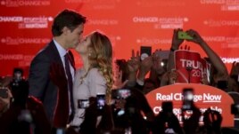 Liberal Party leader Justin Trudeau kisses his wife Sophie Gregoire as he arrives to give his victory speech in Montreal, Quebec, October 19, 2015.