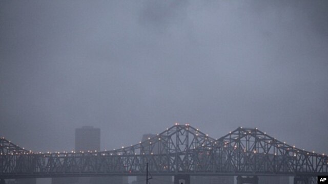 Heavy rain clouds from approaching Tropical Storm Lee form over the skyline of New Orleans and the Crescent City Connection bridges at dusk, September 2, 2011.