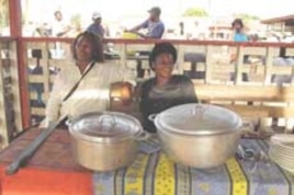 Two women vendors sell bush meat stews at market near Yaounde, Cameroon