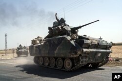 Turkish troops head to the Syrian border, in Karkamis, Turkey, Aug. 27, 2016.