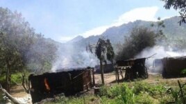 Smoke rises from homes in the village of Chukudum after a rampage by soldiers on Tuesday, Oct. 7, 2014, claimed at least three lives.