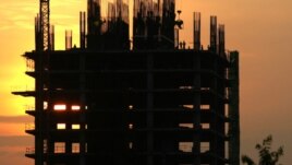 Construction workers work on a new building in Phnom Penh. Cambodia is embracing a thriving real estate market, where land and housing prices in the capital city skyrocket with no sign of letting up, file photo. 