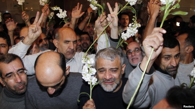 Iranians released by Syrian rebels arrive at a hotel in Damascus, Syria, January 9, 2013. 