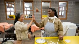 Poor Clares nuns Sister Maria Eden, left, and Sister Thereza share a laugh as they make altar bread also known as communion wafers, Sept. 8, 2015, at the Monastery of Saint Clare in Langhorne, Pa.