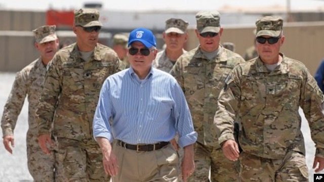 US Secretary of Defense Robert M. Gates walks with a group of service members at Forward Operating Base Waltman, Kandahar, Afghanistan, June 5, 2011