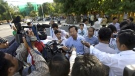 Rong Chhun, rear center, Cambodian Teacher Independence Association's president gives a press conference on a street as he walking to the protesting site, file photo. 