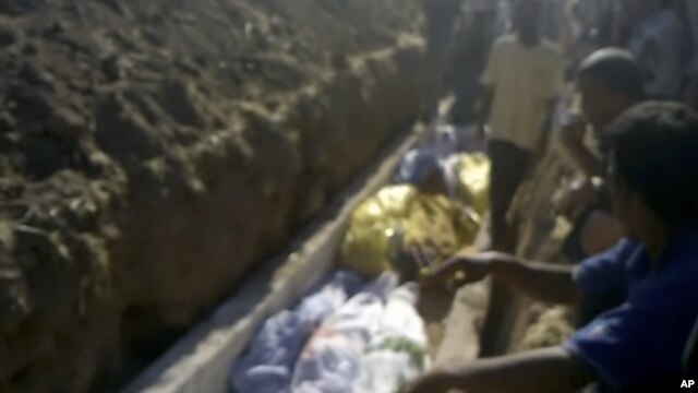 This image made from amateur video on July 13, 2012 purports to show a funeral for victims killed by violence that, according to anti-regime activists, was carried out by government forces in Tremseh, Syria.