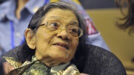 In this photo taken on Oct. 19, 2011 released by the Extraordinary Chambers in the Courts of Cambodia, Ieng Thirith smiles during a hearing in Phnom Penh.