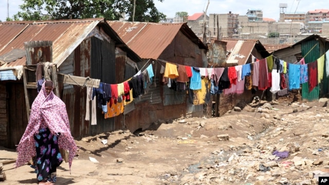 FILE - A woman walks on a street in the Korogocho slums in Kenya's capital Nairobi, April 6, 2011. 