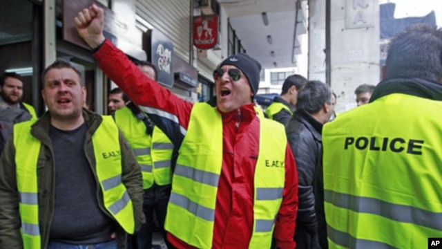 Police officers shout slogans as they protest against their pension fund's participation in the Greek bond swap in Athens March 7, 2012.