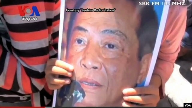 Members of his Association of Democrats gathered in front of the Royal Palace Wednesday, calling for his release. 