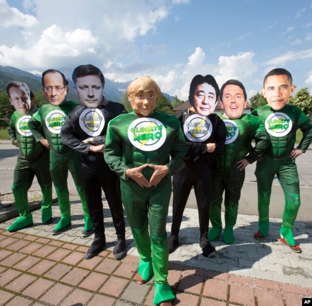 Protestors wearing masks of G-7 leaders during a demonstration one day before the G-7 summit, in Garmisch-Partenkirchen, southern Germany, June 6, 2015. The summit is to take place June 7-8 at Schloss Elmau hotel near Garmisch-Partenkirchen.