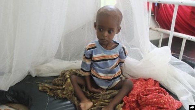 A malnourished child from southern Somalia sits on a bed at Banadir hospital in Mogadishu, Somalia, August 1, 2011
