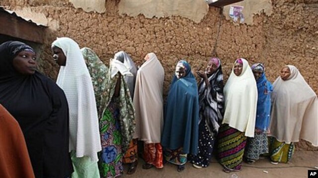 Muslim women line up  at a polling place in Daura, Nigeria, Saturday, April 16, 2011