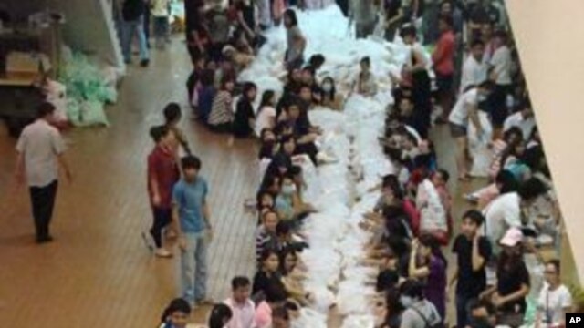 Volunteer relief workers prepare supplies at the Don Muang Airport, Thailand, October 15, 2011.