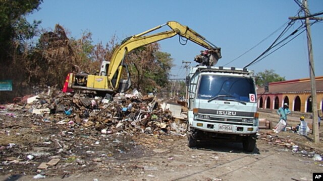 A backhoe performs flood recovery work in Muang Ake, Bangkok.