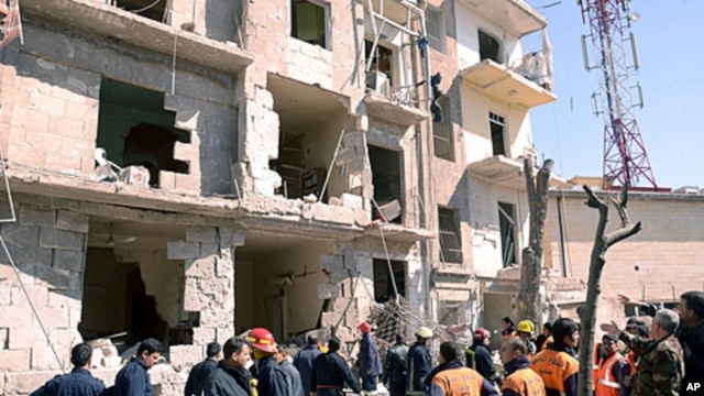 A handout picture released by the official Syrian Arab News Agency (SANA) shows rescue teams inspecting the blast scene in Aleppo March 18, 2012.