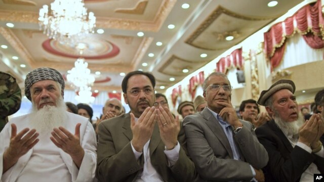 Salahuddin Rabbani (C) prays after he was introduced as the care taker to Jamiat-e Islami party during a gathering at the Kabul Intercontinental Hotel, October 4, 2011. 