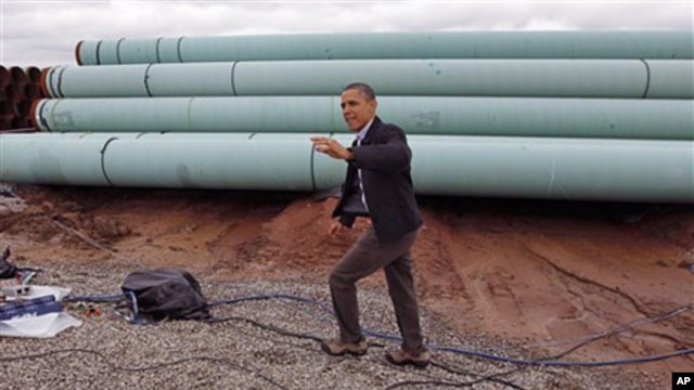 President Barack Obama waves as he arrives at the TransCanada Stillwater Pipe Yard in Cushing, Oklahoma, March, 22, 2012.
