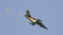 A Syrian Air Force fighter plane fires a rocket during an air strike in the village of Tel Rafat, some 37 km (23 miles) north of Aleppo, August 9, 2012. 
