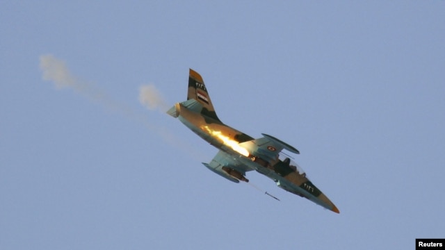 A Syrian Air Force fighter plane fires a rocket during an air strike in the village of Tel Rafat, some 37 km (23 miles) north of Aleppo, August 9, 2012. 