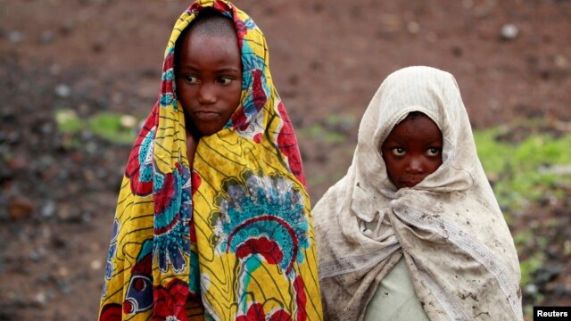 Girls, displaced by recent fighting between Congolese army and the M23 rebels, cover themselves from the cold in Munigi village near Goma in the eastern Democratic Republic of Congo September 1, 2013.