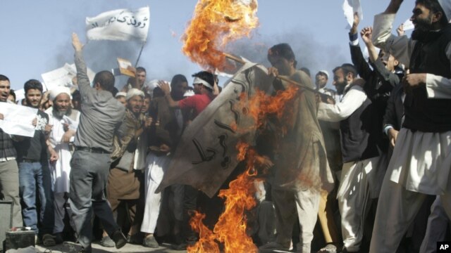 Afghans burn the U.S. flag in Herat, west of Kabul, Afghanistan, Sept. 16, 2012, during a protest against an Internet video mocking the Prophet Muhammad.