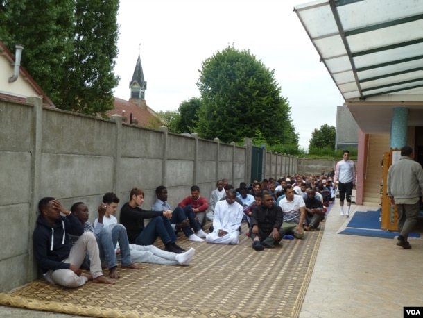 St. Etienne's mosque, next door to St. Therese, the Roman Catholic church that donated land for the mosque's construction, is thriving. An overflow group assembles outside for Friday prayers. (L. Ramirez/VOA)