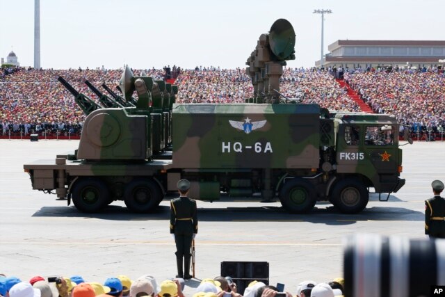 Military vehicles carry radar arrays for HQ-6A surface-to-air missile batteries during a parade commemorating the 70th anniversary of Japan's surrender during World War II held in front of Tiananmen Gate in Beijing, Sept. 3, 2015.