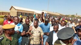 The leader of the Zambian opposition Patriotic Front (PF), Michael "King Cobra" Sata (C), leaves on September 20, 2011 a polling station after inspecting voting procedures in Lusaka during national elections.