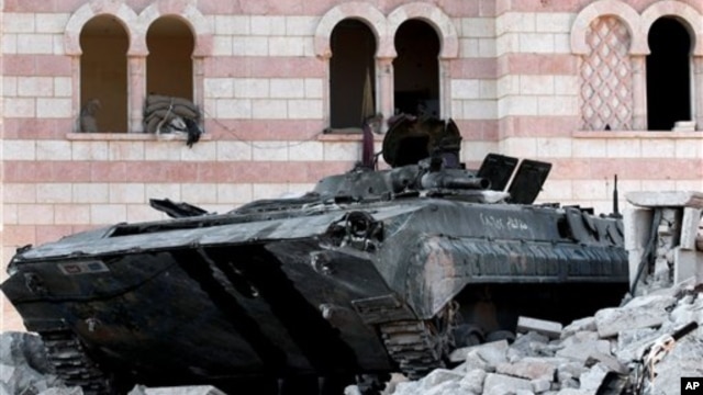 A damaged Syrian military tank is seen at the border town of Azaz, about 20 miles north of Aleppo, Syria, July 24, 2012.