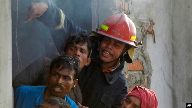 Bangladeshi firefighters and volunteers work to douse a fire at a two-storied garment factory in Dhaka, Bangladesh, January 26, 2013.