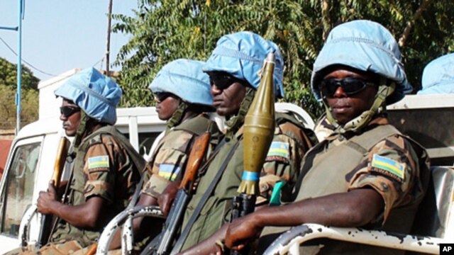 The blue helmets of UN peacekeepers distinguish them from the many armed groups in Darfur.
