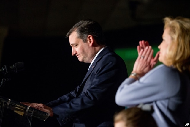 Republican presidential candidate Sen. Ted Cruz, accompanied by his wife, Heidi, right, pauses while speaking at his South Carolina primary night rally at the South Carolina State Fairgrounds in Columbia, Feb. 20, 2016.