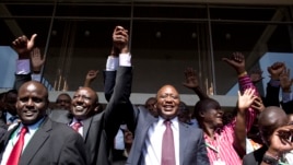 Kenya's presidential candidate Uhuru Kenyatta (C) and his running mate William Ruto (2nd L) celebrate winning the presidential election with supporters after the official result was released in Nairobi, March 9, 2013. 