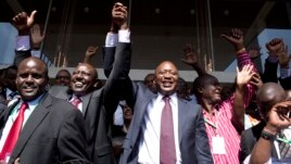 Kenya's presidential candidate Uhuru Kenyatta (C) and his running mate William Ruto (2nd L) celebrate winning the presidential election with supporters after the official result was released in Nairobi, March 9, 2013. 