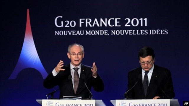 European Council President Herman Van Rompuy (L) gestures as European Commission President Jose Manuel Barroso (R) looks on during a news conference on the second day of the G20 Summit in Cannes November 4, 2011.