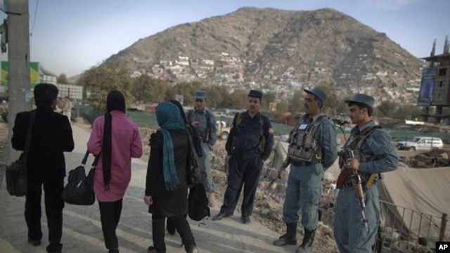 Afghan policemen keep watch near the site where a suicide bomber was killed near the location of the Loya Jirga, or the traditional assembly, in Kabul, November 14, 2011.