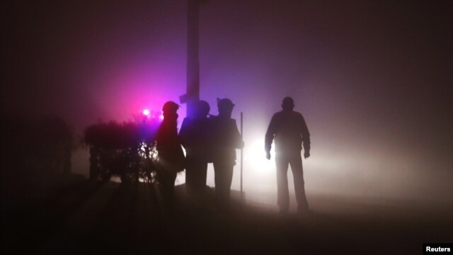 Policemen stand guard outside the cremation ground during the funeral of a rape victim after her body arrived from Singapore, in New Delhi, December 30, 2012. 