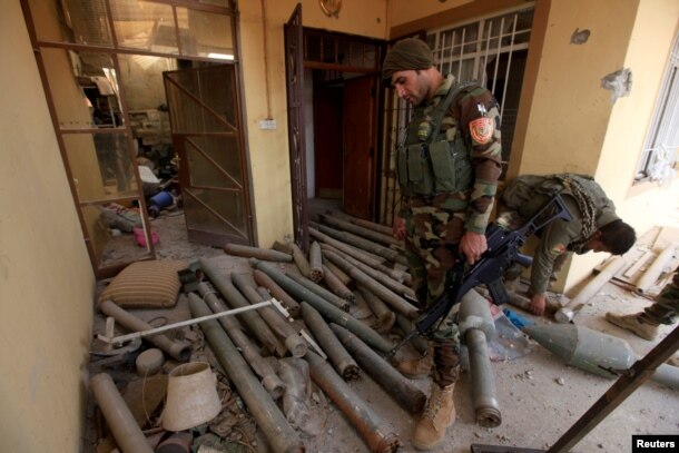 A member of Peshmerga forces inspects a house that was used by Islamic State militants in the town of Bashiqa, after it was recaptured from the Islamic State, east of Mosul, Iraq Nov. 10, 2016.