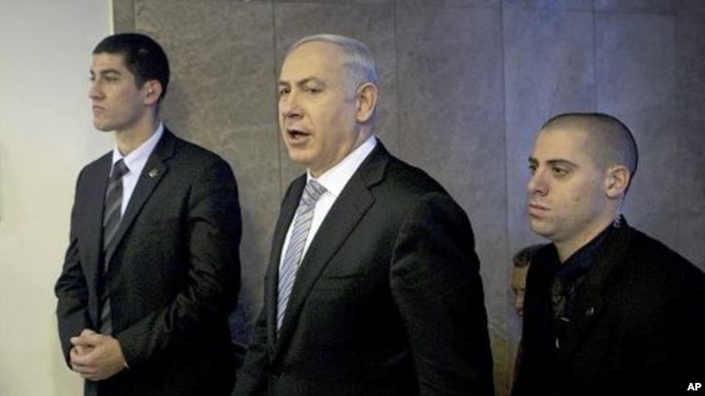 Israel's Prime Minister Benjamin Netanyahu, center, arrives at the weekly cabinet meeting in Jerusalem, February 5, 2012.