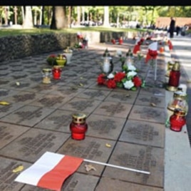 Candles, flowers and Polish flags mark gravestones of Polish officers killed 70 years ago by Soviet secret police in the Katyn massacre, during commemorating events in Kharkiv, Ukraine (File)