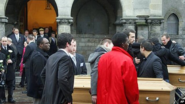 Relatives leave the funeral of Vincent Delory and Antoine De Leocour in Linselles, northern France, 17 Jan 2011