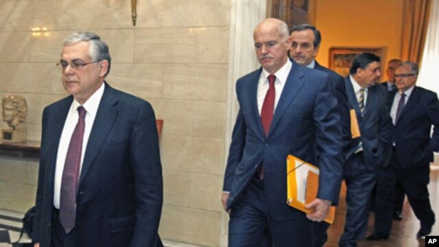 Greece's Prime Minister Lucas Papademos (L) escorts Socialist leader George Papandreou (C), conservative party leader Antonis Samaras (3rd L) and Far-right leader George Karatzaferis (2nd R) at his office in Athens, February 8, 2012.