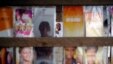 A poster of incumbent President Alassane Ouattara, center rear, is seen at a local hair dressing salon in Abidjan, Ivory Coast, Oct. 21, 2015.
